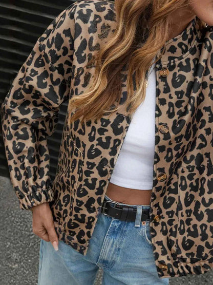 Leopard print casual button-up jacket with long sleeves and elastic cuffs, worn with white crop top and blue jeans.